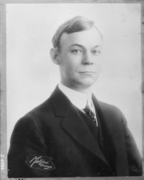 Quarter-length studio portrait of a F.W. Heiskell wearing a suit. International Harvester Advertising Manager.