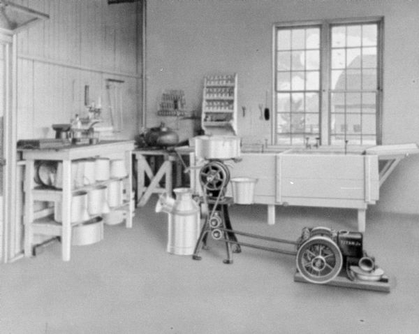 Titan Jr. engine powering a cream separator in a farm building.