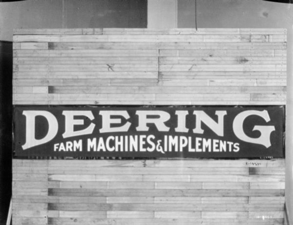 Deering Farm Machines & Implements logo on a banner.