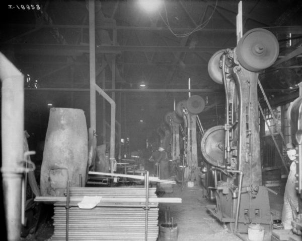 Men are working in a large factory building at McCormick Works.