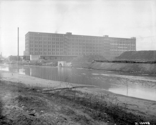 View from shoreline across water towards McCormick Works buildings.