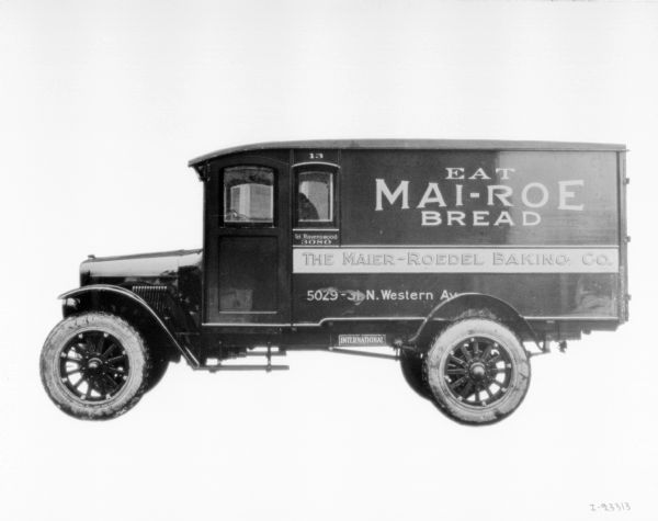 Driver's side view of International truck with an advertisement for  Mai-Roe Bread (Maier-Roedel Baking Company) bakery.