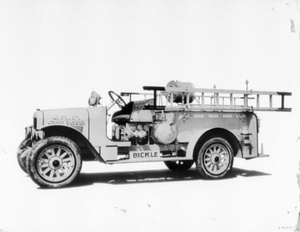 Left side view of a fire truck. Signs on the front reads: "C.A.F. Camp Border." Along the running board is a sign that reads: "Bickle."