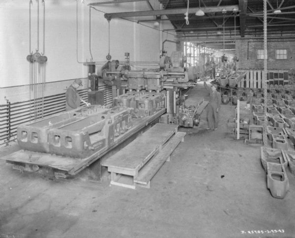 Elevated view of two men working in a manufacturing area on a factory floor.