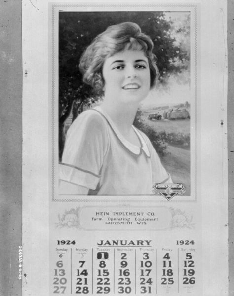 A McCormick-Deering calendar with a pinup girl. Attached to the calendar is a label for the "Hein Implement Co., Farm Operating Equipment, Ladysmith, WI."