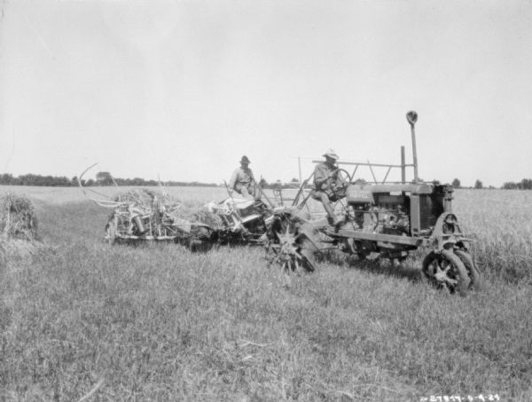 Men using binders, attachements, and bunchers in a field with a Farmall tractor.
