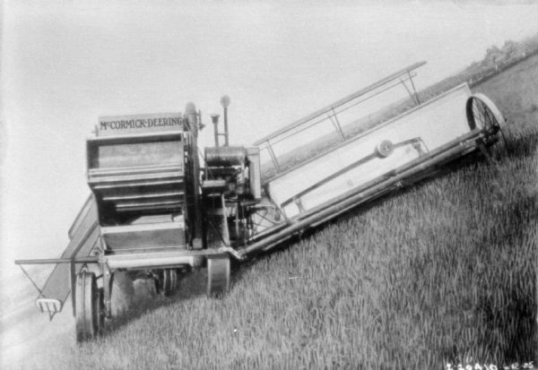 Rear view of a harvester thresher on a hillside.