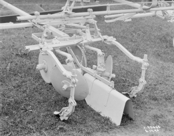 Close-up of cultivator on display on a lawn.