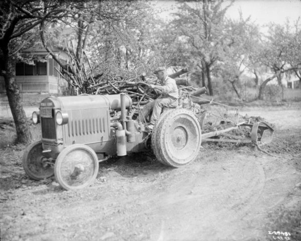 Left side view of a man driving a tractor.