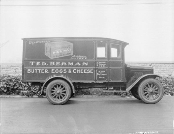 Right side view of the Ted. Berman delivery truck. The sign painted on the side reads: "Buy a Pound today, Friedman's Oak Grove Brand Oleomargarine." and "Butter, Eggs & Cheese."