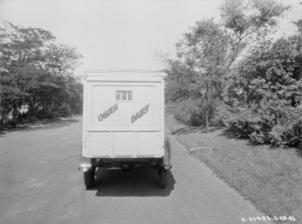 Rear view of a delivery truck for Ogden Dairy Co. parked outdoors.