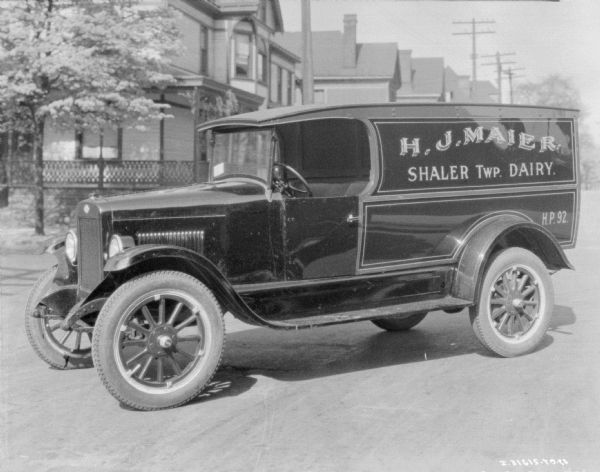 View of a dairy delivery truck parked in the middle of a street. The signs on the side of the truck reads: "H.J. Maier, Shaler Twp. Dairy."