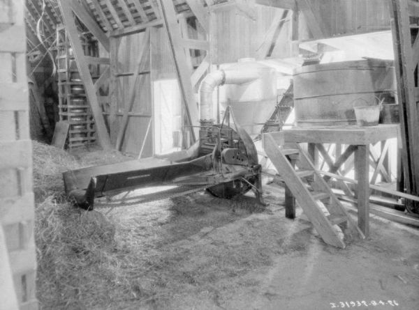 View of a grain mill inside a barn.