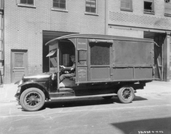 Delivery truck parked at the curb. The sign on the side of the truck reads: "Monroe Express Co."