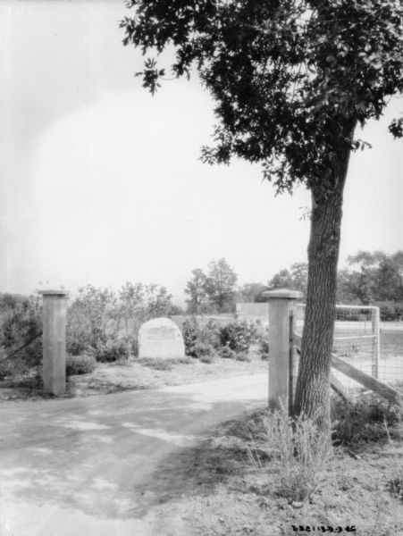 View towards the entrance gate to the Katherine Legge Memorial. There is a stone just inside the gate on the left with an inscription on it.