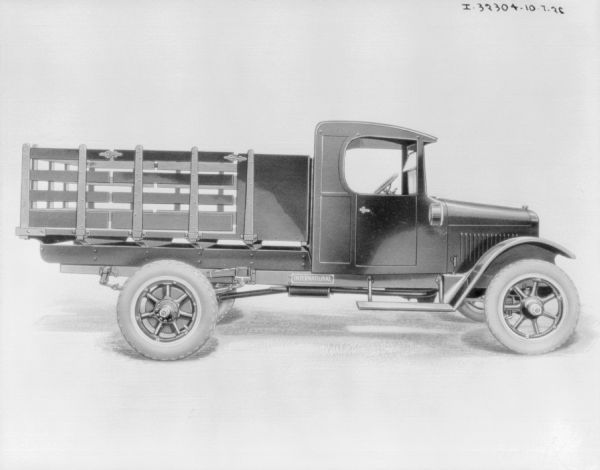 Right side profile view of a truck with a stake bed.