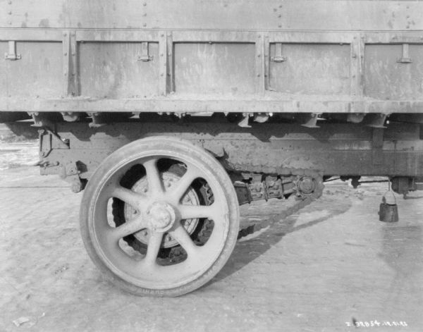 Close-up of rear right wheel and side of truck bed of a delivery/dump truck.