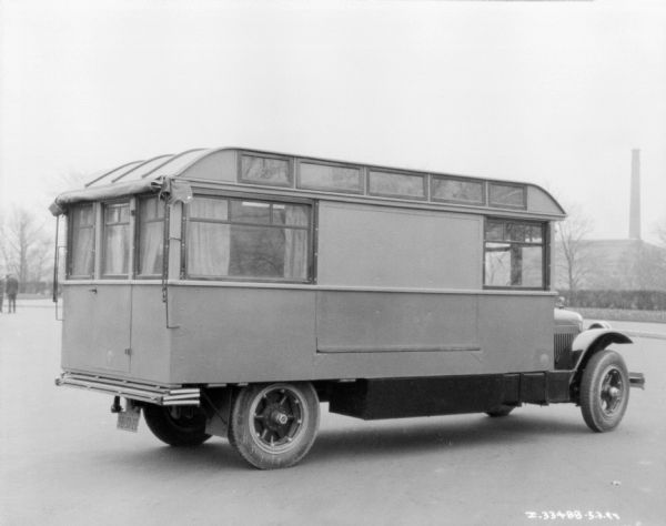 Three-quarter view from right rear of a truck converted to a bus.