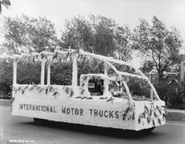 The truck is decorated with plants and flowers, and the sign on the side reads: "International Motor Trucks," at the Am Foundrymen's 31st Annual Convention.