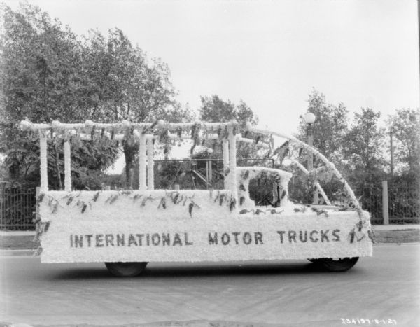 The truck is decorated with plants and flowers, and the sign on the side reads: "International Motor Trucks," at the Am Foundrymen's 31st Annual Convention.