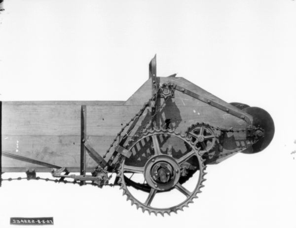 Close-up of side view of a section of a manure spreader.