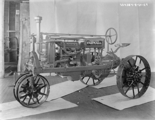 Left side view of a McCormick-Deering Farmall tractor parked indoors.