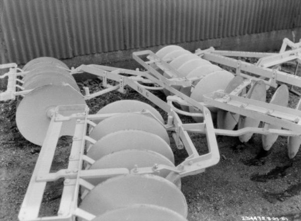 Side view of a disk harrow, with "No. 6" painting on the back.