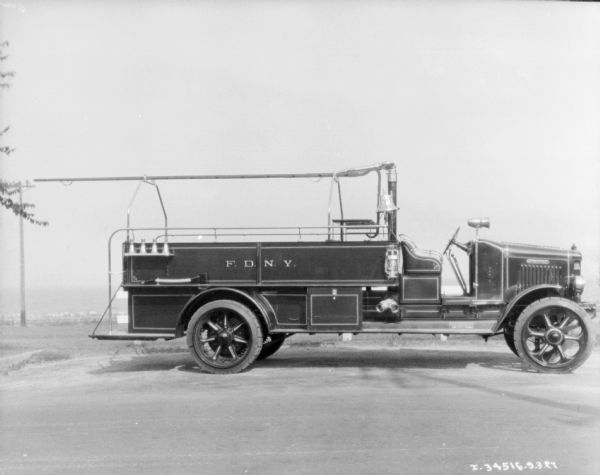 Right side profile view of a fire truck parked along a curb. The sign painted on the side of the truck reads: "F.D.N.Y."