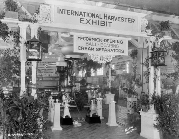 Indoor IH exhibit. A large oversize cream separator is in the center of a display of ball bearing cream separators.