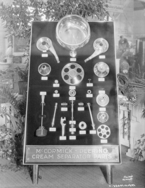 A display of McCormick-Deering cream separator parts on a board. 