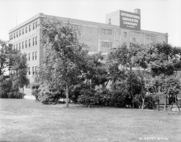 View across lawn and trees towards the International Harvester Company plant.