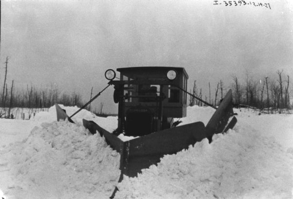 View from front of a man snowplowing in deep snow.