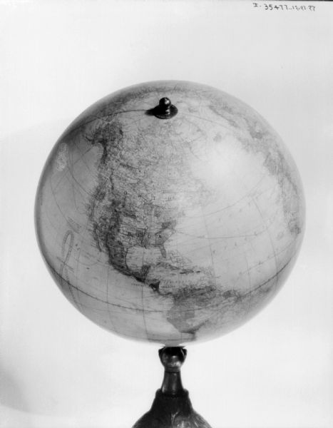 An earth globe on a stand, featuring North America.