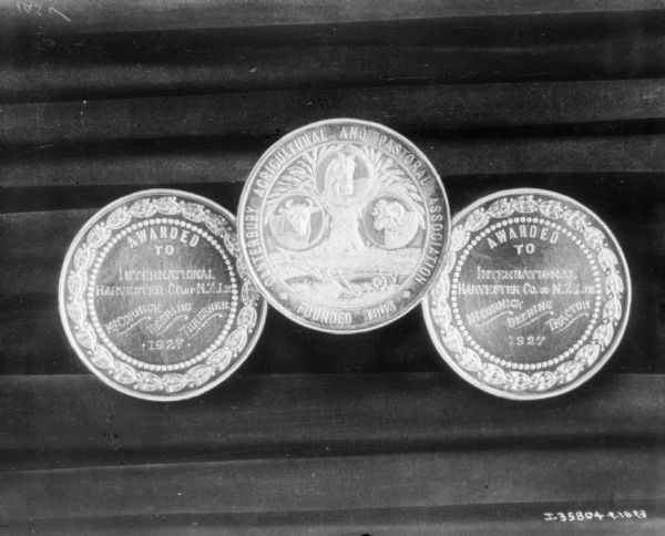 Three commemorative coins. The center coin reads: "Canterbury Agricultural and Pastoral Association."