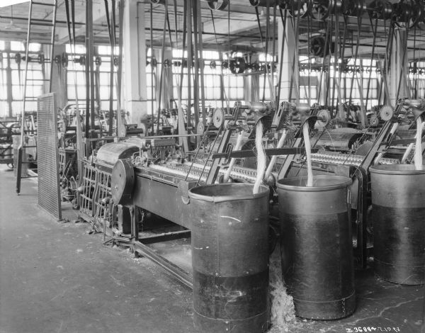 Manufacturing machines for making twine on a factory floor.