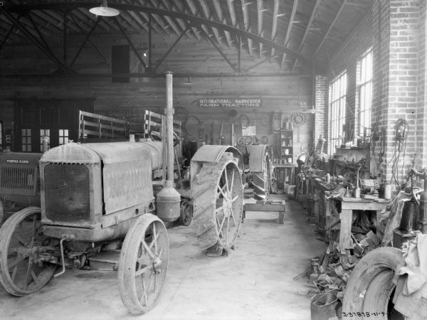Interior view of a dealership with a tractor on display.