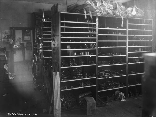 Interior view of parts on storage shelves, and supplies at a repair shop at an implement store.