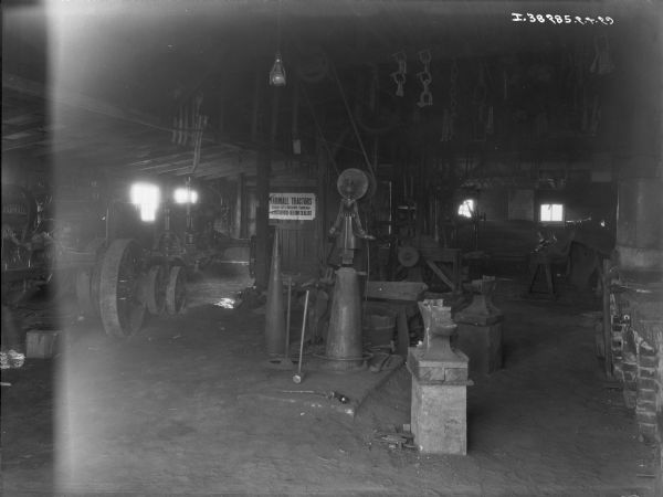 Farmall tractors in the Harry See Blacksmith Shop for repair.