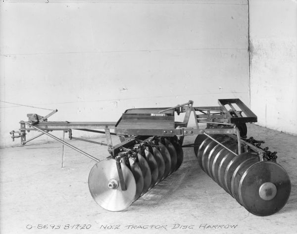 No. 2 tractor disc harrow set up in the corner of a room.