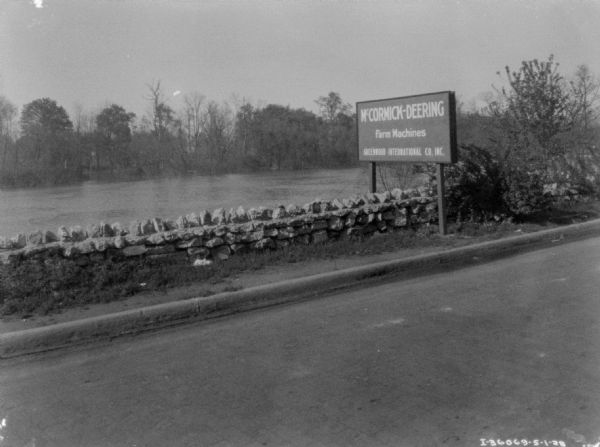 View across road towards a sign that reads: "McCormick-Deering Farm Machines Greenwood International Co. Inc."
