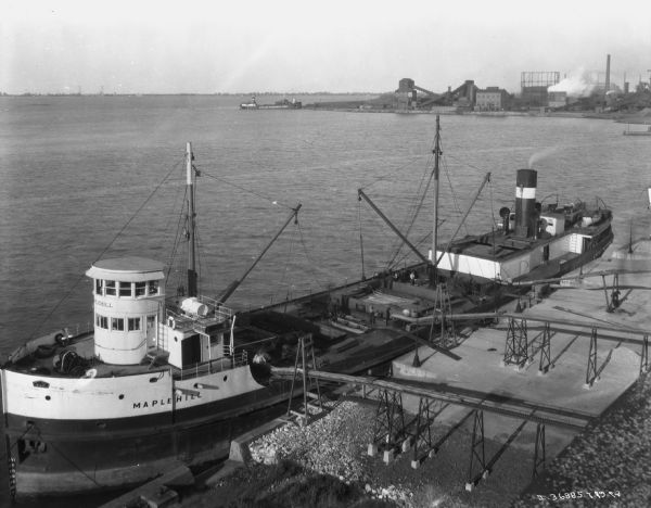 Elevated view of a ship at dock. The name of the ship is <i>Maplehill</i>. Label reads: "IH twine mills have a capacity of more, than 100,00 tons a year ... to every pt of the world..."