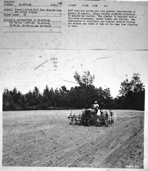 Three-quarter view from front left towards a man driving a Farmall M in a field. Subject: "Farmall M with M-57 Rear Mounted corn and cotton planter." Where Taken: "SE." Information with photograph reads: "M-57 four-row cotton and corn planter rear-mounted on Farmall M tractor. Front section of M-448 cultivator is mounted on tractor. The planter is equipped with a hill-drop attachment, runner blades and shields. The combination of cultivator and planter permits working the middles and sides of beds at the same time planting is done."