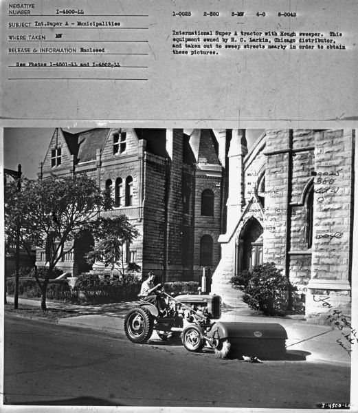 View across streeet towards a man using a Super A tractor with sweeper to clean streets. Subject: "Int. Super A — Municipalities." Where Taken: "MW." Information with photograph reads: "International Super A tractor with Hough sweeper. This equipment owned by R.C. Larkin, Chicago distributor, and taken out to sweep streets nearby in order to obtain these pictures."