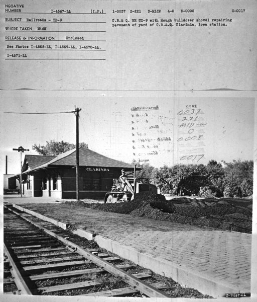 Subject: "Railroads — TD-9." Where Taken: "MidW." Information with photograph reads: "C.B.& Q. RR TD-9 with Hough bulldozer shovel repairing pavement of yard of C.B.& Q. Clarinda, Iowa station."