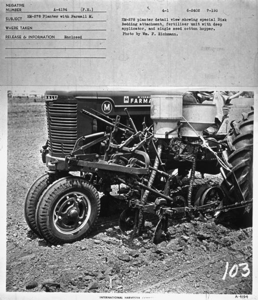 Left side view of front of tractor with planter. A man, (partially out of frame) is sitting on the tractor seat. Subject: "HM-278 Planter with Farmall M." Information with photograph reads: "HM-278 planter detail showing special Disk Bedding attachment, fertilizer unit with deep applicator, and single seed cotton hopper. Photo by Wm. F. Eichmann."