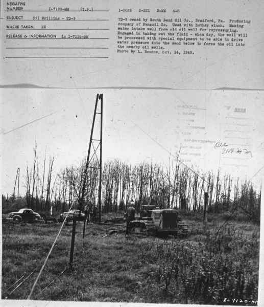 Subject: "Oil Drilling — TD-9." Where Taken: "NE." Information with photograph reads: "TD-9 owned by South Bend Oil Co., Bradford, Pa. Producing company of Penzoil Co. Used with Luther winch. Making water intake well from old oil well for repressuring. Engaged in taking out the fluid — when dry, the well will be processed with special equipment to be able to drive water pressure into the sand below to force the oil into the nearby oil wells. Photo by L. Bouche, Oct. 14, 1949."