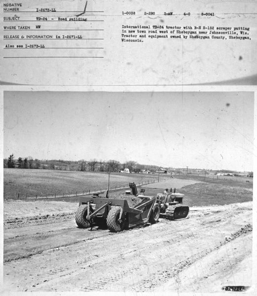 Subject: "TD-24 — Road Building." Where Taken: "MW." Information with photograph reads: "International TD-24 Tractor with B-E S-152 scraper putting in new town road west of Sheboygan near Johnsonville, Wis. Tractor and equipment owned by Sheboygan County, Sheboygan, Wisconsin."