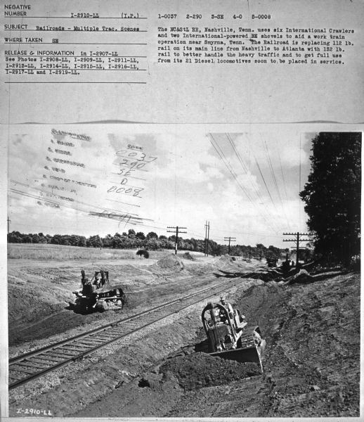 Subject: "Railroads — Multiple Trac. Scenes." Where Taken: "SE." Information with photograph reads: "The NC&StL RR, Nashville, Tenn. uses six International Crawlers and two International-powered BE shovels to aid a work train operation near Smyrna, Tenn. The Railroad is replacing 112 lb. rail on its main line from Nashville to Atlanta with 132 lb. rail to better handle the heavy traffic and to get full use from it 21 Diesel locomotives soon to be placed in service."
