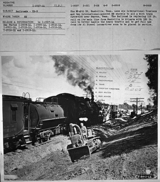 Subject: "Railroads — TD-9." Where Taken: "SE." Information with photograph reads: "The NC&StL RR, Nashville, Tenn. uses six International Crawlers and two International-powered BE shovels to aid a work train operation near Smyrna, Tenn. The Railroad is replacing 112 lb. rail on its main line from Nashville to Atlanta with 132 lb. rail to better handle the heavy traffic and to get full use from its Diesel locomotives soon to be placed in service."
