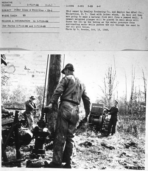 Subject: "Power Lines & Utilities — TD-6." Where Taken: "NE." Information with photograph reads: "TD-6 owned by Bradley Producing Co. and Empire Gas & Fuel Co., Wellsville, N.Y. Used with Luther winch. In this job they are going to make a natural flow well from a pumped well. A cement weighted plunger will be placed in well which will force the  oil up the tubing as the water pressure from surrounding water wells pushes the oil through the sand to the oil pool below. Photo by L. Bouche, Oct. 19, 1949."	